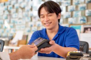 Main focus on credit card of Asian worker or staff at office reception receive credit card